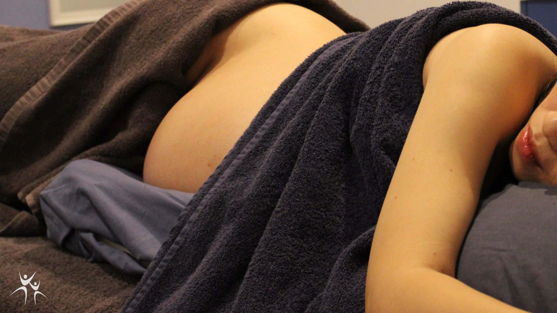 woman laying on side for pregnancy massage at Rapid Recovery Clinic in Healesville