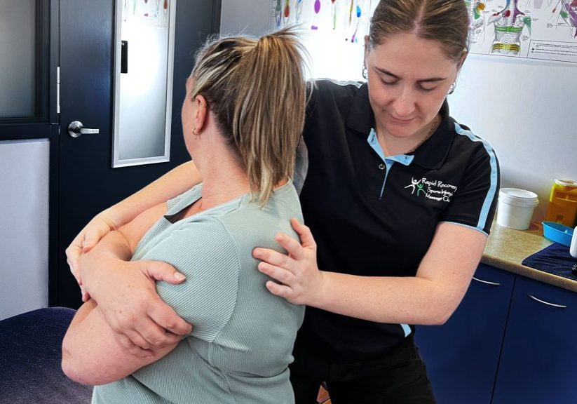 Dr Meave Bohanna examines a seated patients upper back