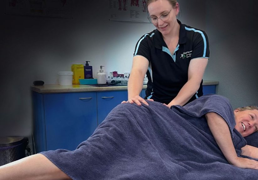 Advanced myotherapist Haydie treating a female client lying on bed