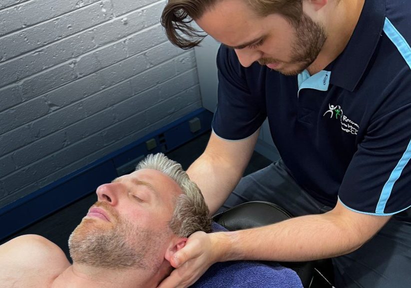 Dr Mitch Pontefract (osteopath) holding concussion patient head