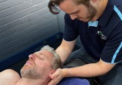 Dr Mitch Pontefract (osteopath) holding concussion patient head