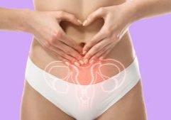 Women making a heart symbol over her belly button with a diagram of her pelvic region etched across the image