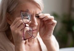 elderly woman rubbing her tired eyes