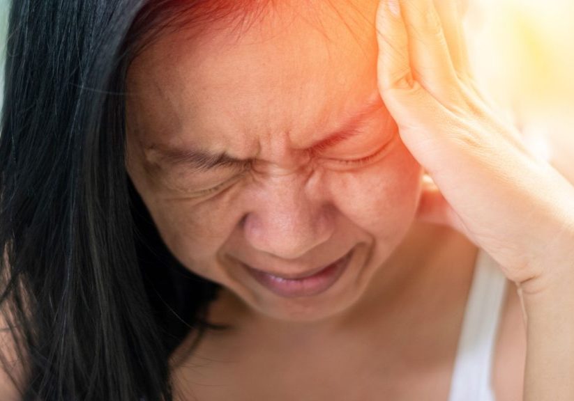 Woman experiencing a painful migraine headache